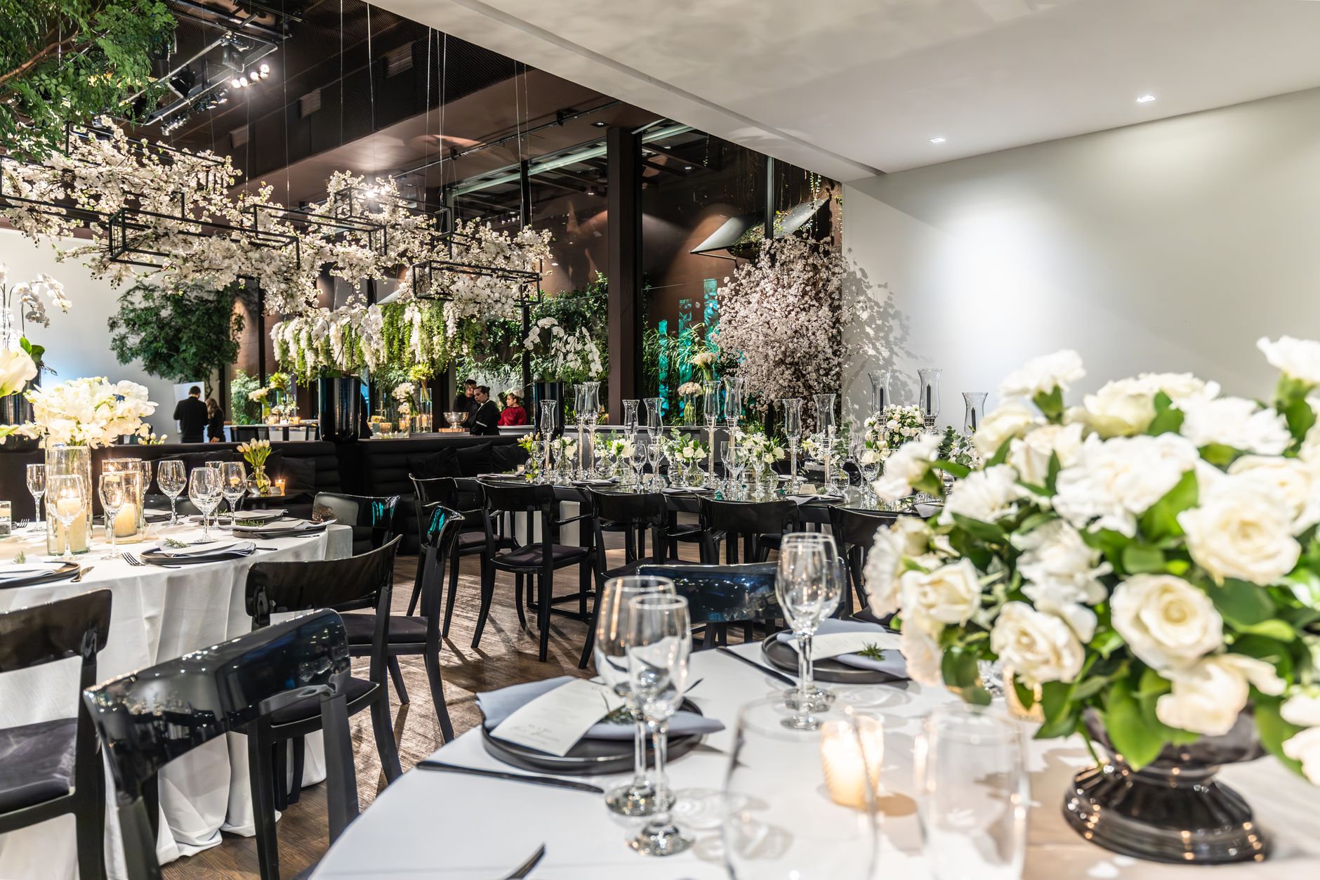 Beautifully arranged wedding venue with flowers, table settings, and wineglasses. — Learn how to access the Italian cabinet m