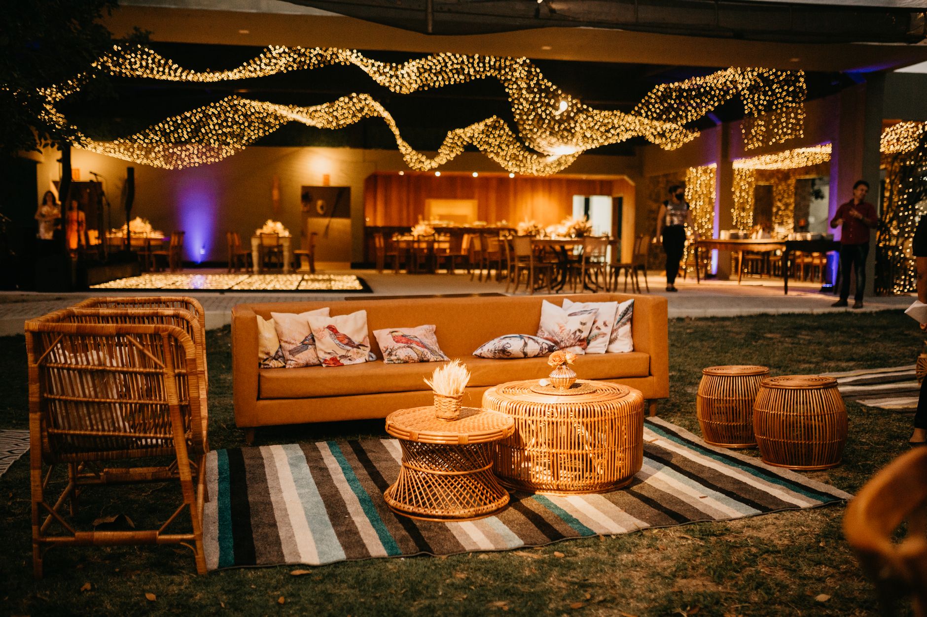 Warm outdoor seating with wicker furniture and ambient lighting for an elegant evening event. — The Fireplace and Home Decor