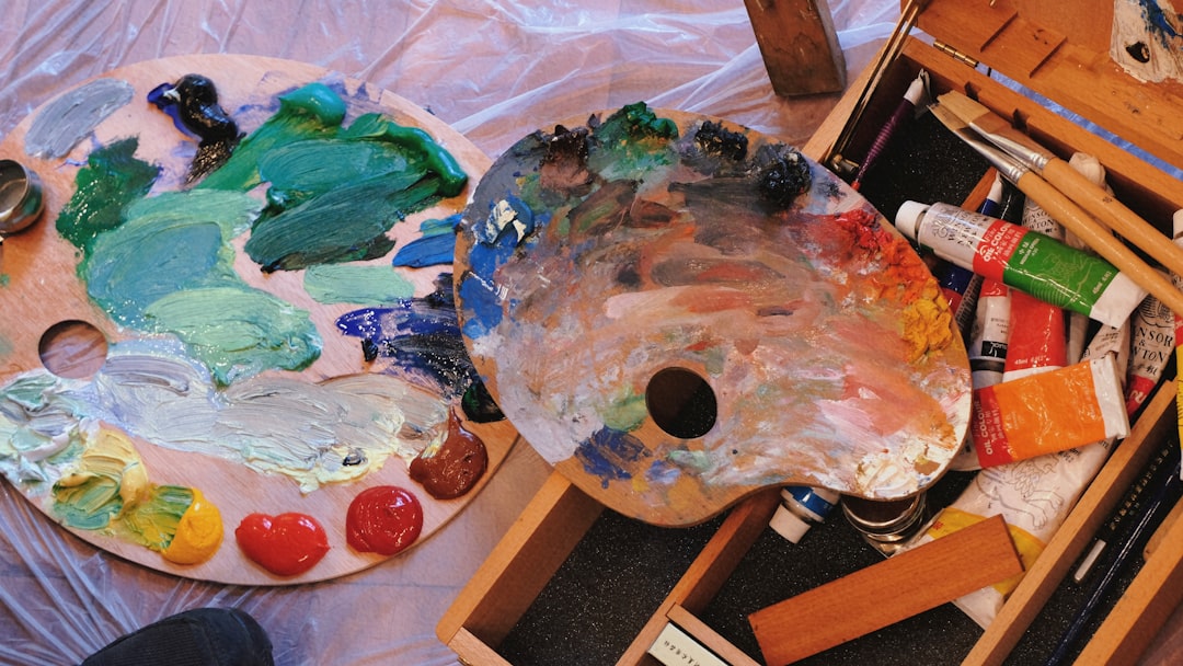 paint palettes and paint tubes in an artist's workspace